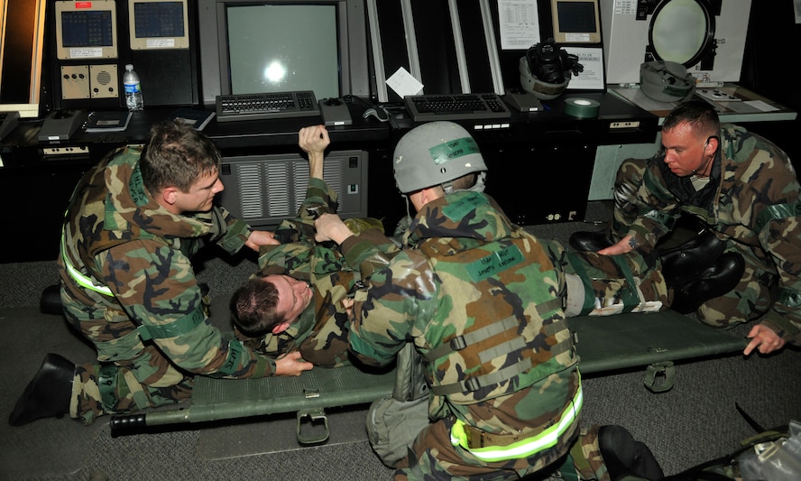 Members from the 8th Operations Support Squadron carry an injured Airman during an exercise at Kunsan Air Base, Republic of Korea, July 10, 2012. Members from the medical team evaluated the 8th OSS Airmen while they performed self-aid buddy care. (U.S. Air Force photo/ Senior Airman Marcus Morris)