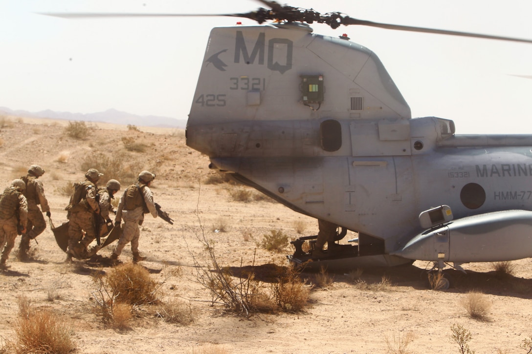 Marines load onto a CH-46 Sea Knight helicopter after retrieving two Marines during a tactical recovery of aircraft and personnel exercise as part of Javelin Thrust 2012 on Marine Corps Air Ground Combat Center Twentynine Palms, Calif., July 9, 2012. 