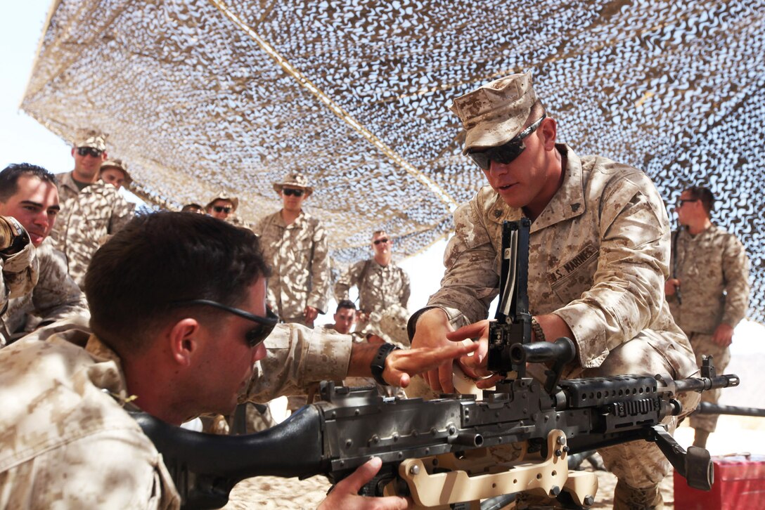 Military police demonstrate loading and clearing procedures for the M240B machine gun before a crew-served weapons shoot during Exercise Javelin Thrust 2012 in Twentynine Palms, Calif., July 8, 2012. The annual exercise on Marine Corps Air Ground Combat Center Twentynine Palms allows Marines and sailors from 38 states to train together. 