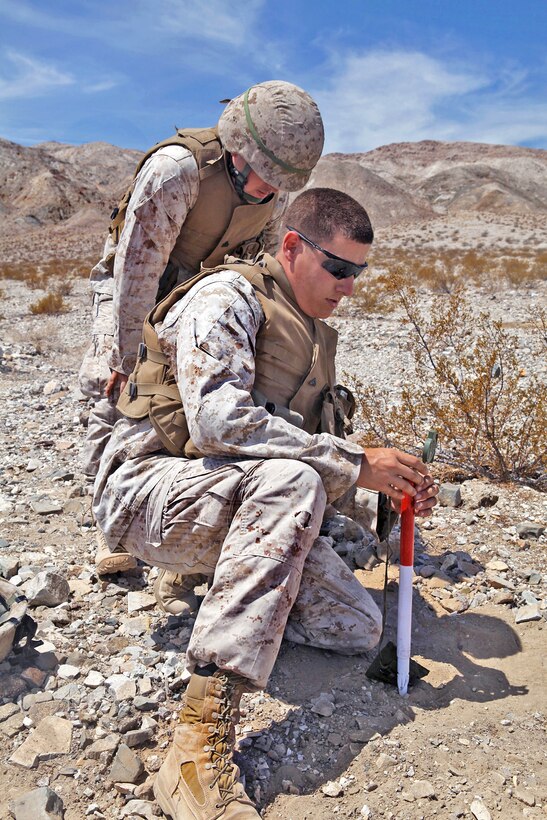 Marine Corps Sgt. Joseph Benson, rear, and Cpl. John Leiby, front, shoot an azimuth for an 81mm mortar cannon during an exercise as part of Javelin Thrust 2012 on Marine Corps Air Ground Combat Center Twentynine Palms, Calif., July 10, 2012. Benson and Leiby, both mortarmen, are assigned to the 2nd Battalion, 25th Marine Regiment.