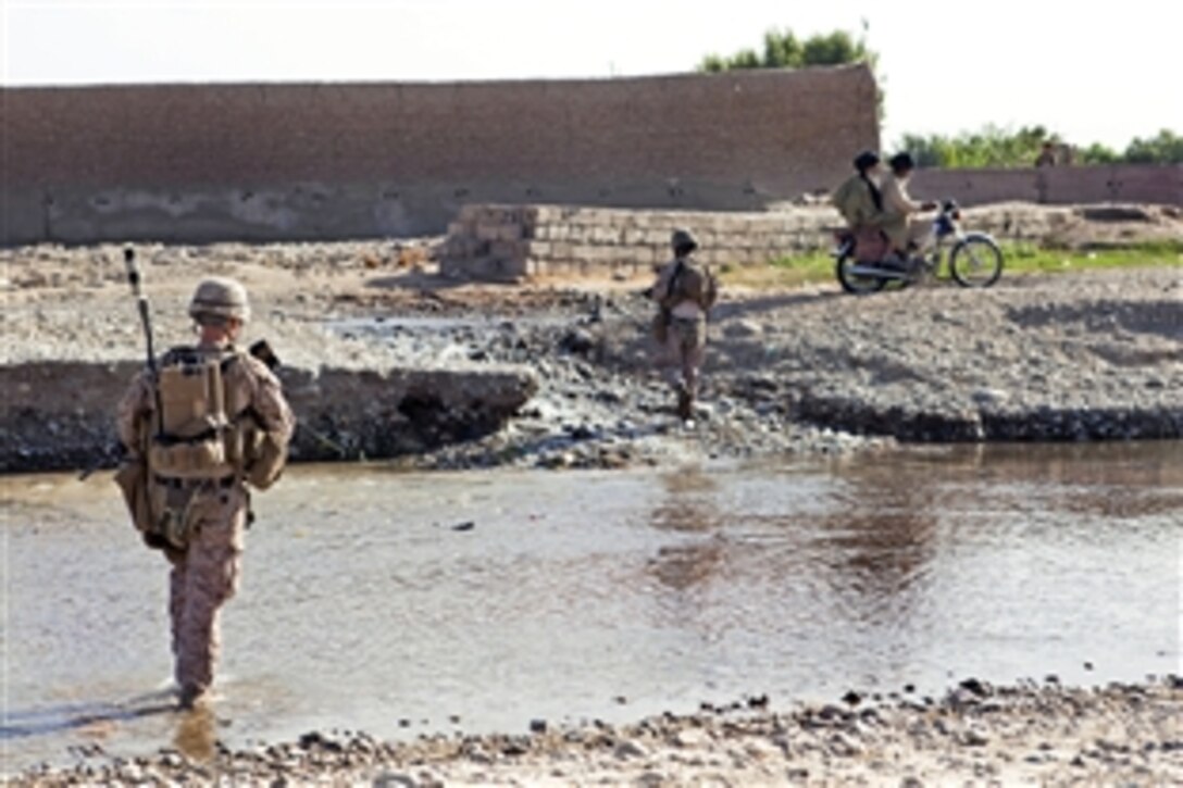U.S. Marine Corps Lance Cpl. Paul Grimm, foreground, patrols in Sangin in Afghanistan's Helmand province, July 3, 2012. Grimm, a rifleman, is assigned to Police Advisor Team 2, Alpha Company, 1st Battalion, 7th Marine Regiment, Regimental Combat Team 6. The Marines were on their way to train Afghan Local Police recruits.