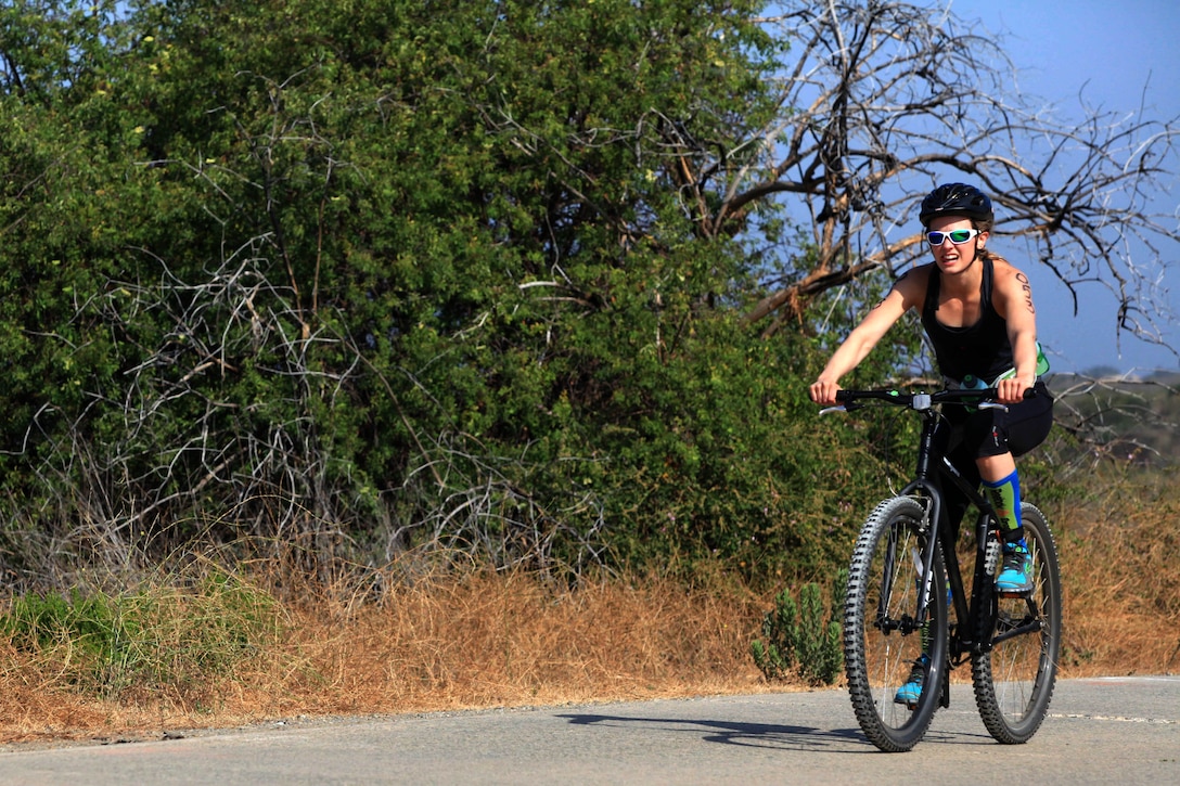 Thuridur Erla Helgadottir reaches the end of the biking event where she began her trek up Microwave Mountain during the 2012 Reebok CrossFit Games in the hills of Las Pulgas, July 12. CrossFit athletes competed in a true test of fitness that included swimming 700-meters in the Pacific Ocean, biking 6-miles through grueling terrain, running up more than 1400 vertical feet and ending the day’s events by maneuvering their way though a Marine Corps Obstacle Course.