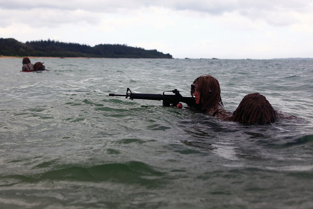 Marines wash up to the shore at Kin Blue Training Area during a scout swimmers course April 30. Marines learned how to operate using different methods of entry and egress from the beach. The technique known as washing up allows Marines to use the natural effects of the waves to carry them ashore.
