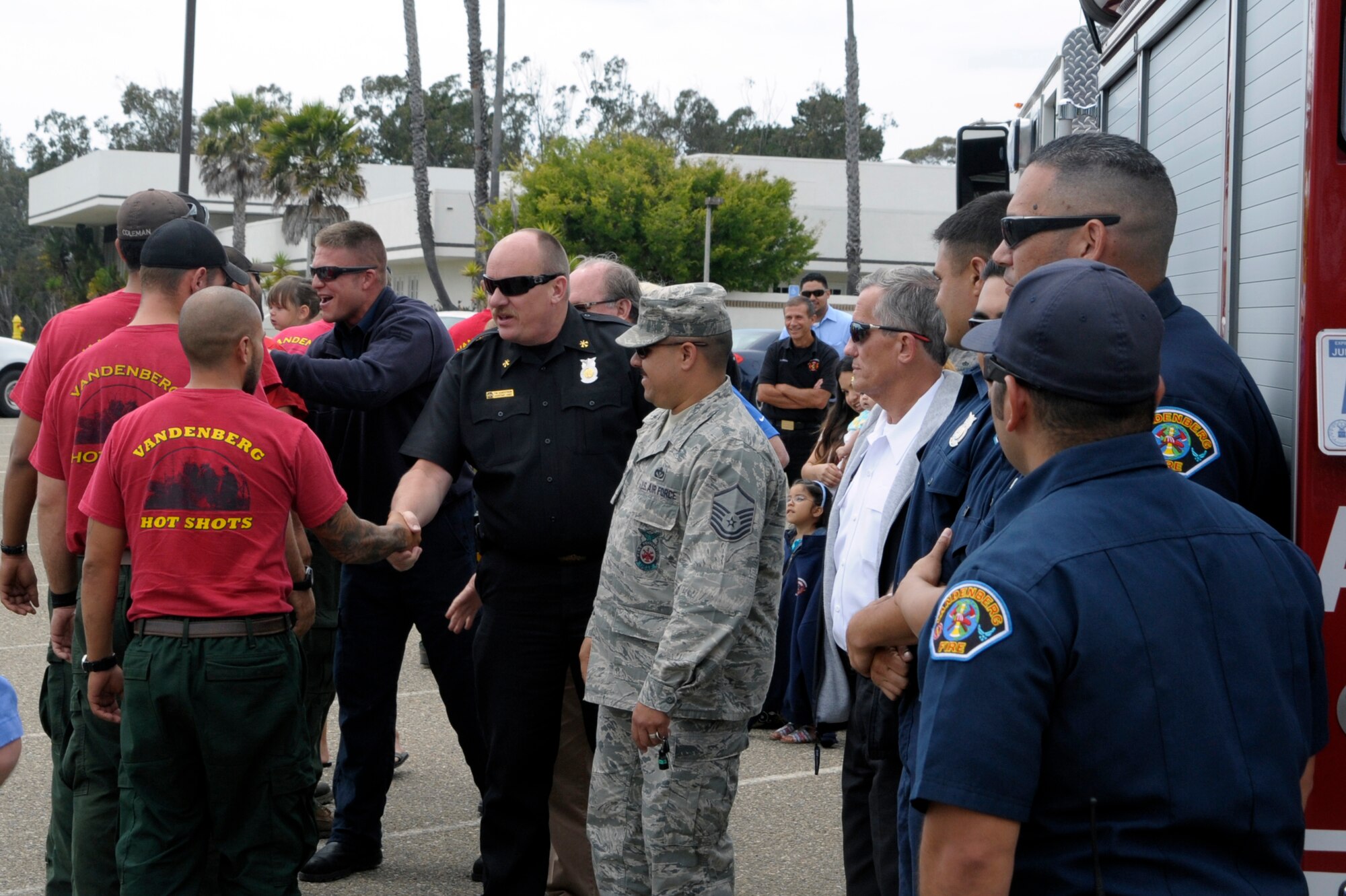 VANDENBERG AIR FORCE BASE, Calif. -- Team Vandenberg members greet returning Vandenberg Hot Shots crew members here, Thursday, July 12, 2012. The Hot Shots were fighting wildfires in Colorado and Wyoming, which burned 29,168 acres total and destroyed nearly 350 houses in Colorado. (U.S. Air Force photo/Jerry E. Clemens Jr.) 