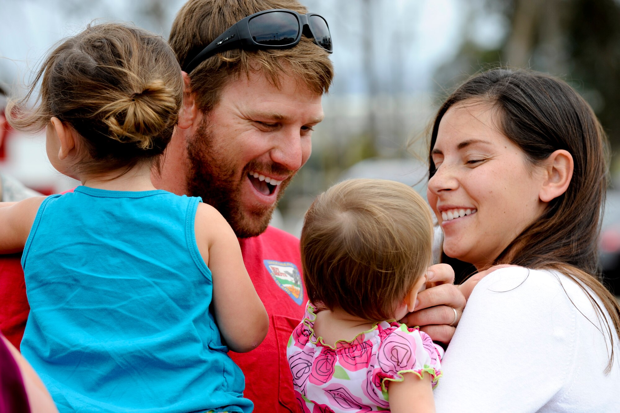 VANDENBERG AIR FORCE BASE, Calif. -- Trent Ogan, a member of the Vandenberg Hot Shots crew, embraces his family outside the Pacific Coast Club here after returning from fighting wildfires in Colorado and Wyoming Thursday, July 12, 2012. Wildfires in Colorado and Wyoming burned 29,168 acres total and destroyed nearly 350 houses in Colorado. (U.S. Air Force photo/Staff Sgt. Levi Riendeau)