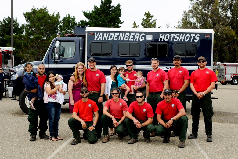 VANDENBERG AIR FORCE BASE, Calif. -- Members of the Vandenberg Hot Shots pose for a photo outside the Pacific Coast Club here after returning from fighting wildfires in Colorado and Wyoming Thursday, July 12, 2012. Wildfires in Colorado and Wyoming burned 29,168 acres total and destroyed nearly 350 houses in Colorado. (U.S. Air Force photo/Staff Sgt. Levi Riendeau)