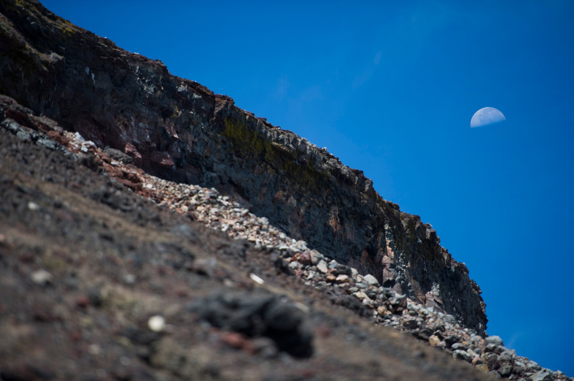 MOUNT FUJI, Japan -- The moon shines behind Mount Fuji on July 11, 2012. After its last volcanic eruption in 1707, Mount Fuji has been almost completely covered in lava rocks. (U.S. Air Force photo by Staff Sgt. Chad C. Strohmeyer)
