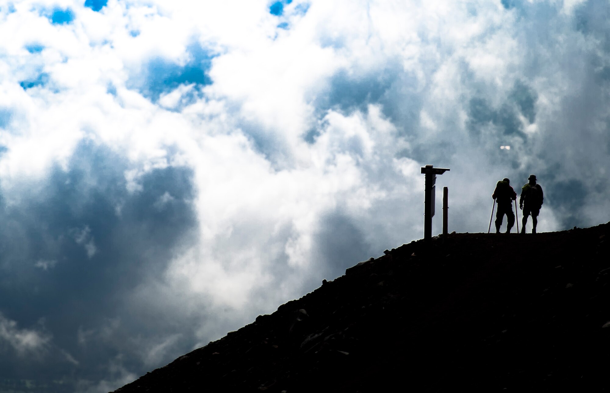 MOUNT FUJI, Japan -- Two men rest near a Torii Gate on the Subashiri trail on Mount Fuji, July 11, 2012. With a distance of 6,494 feet, the Subashiri trail is one of the shortest in length compared to other popular routes. (U.S. Air Force photo by Staff Sgt. Chad C. Strohmeyer)