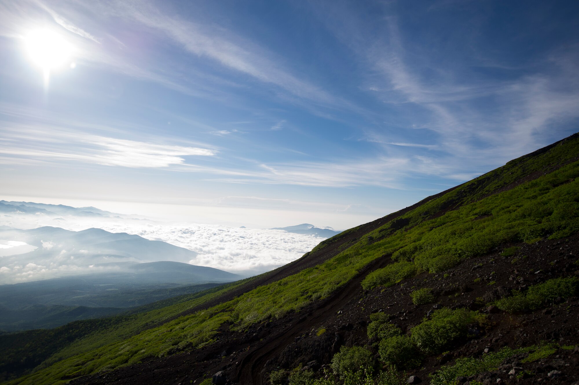 MOUNT FUJI, Japan -- The sun rises in the distance near Mount Fuji on July 11, 2012. At 12,389 feet, Mount Fuji is the tallest mountain in Japan. (U.S. Air Force photo by Staff Sgt. Chad C. Strohmeyer)