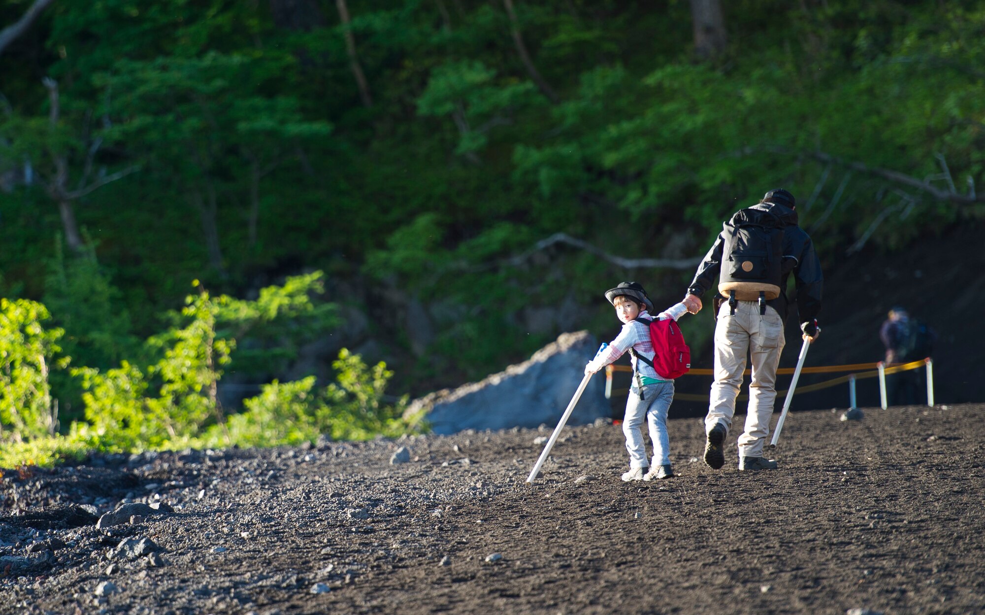 MOUNT FUJI, Japan -- A Japanese father and son begin the climb up Mount Fuji using the Yoshida trail on July 11, 2012. More than 240,000 people climb Mount Fuji every year. (U.S. Air Force photo by Staff Sgt. Chad C. Strohmeyer)