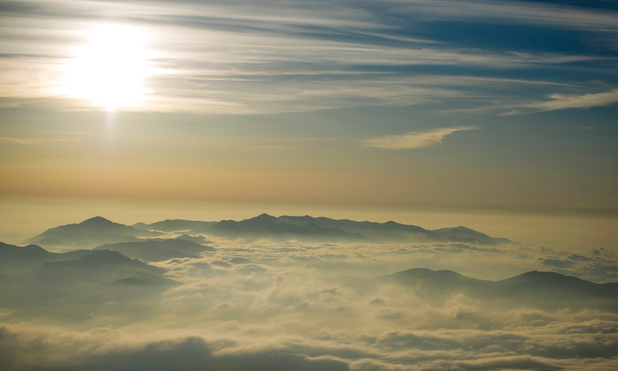 MOUNT FUJI, Japan -- The sun rises in the distance near Mount Fuji on July 11, 2012. At 12,389 feet, Mount Fuji is the tallest mountain in Japan. (U.S. Air Force photo by Staff Sgt. Chad C. Strohmeyer)