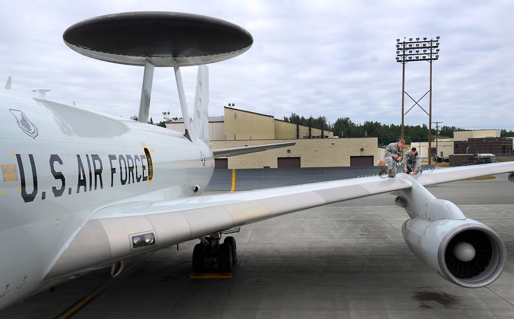 JOINT BASE ELMENDORF-RICHARDSON, Alaska -- Senior Airmen Brandon Ansbro and Michael Dawson, both crew chiefs with the 703rd Aircraft Maintenance Squadron, perform an over wing inspection on an E-3 Sentry Airborne Warning and Control System assigned to the 962nd Airborne Air Control Squadron, July 2. Ansbro is from Missoula, Mont., and Dawson is from Mansfield, Pa. (U.S. Air Force photo by Staff Sgt. Cynthia Spalding)