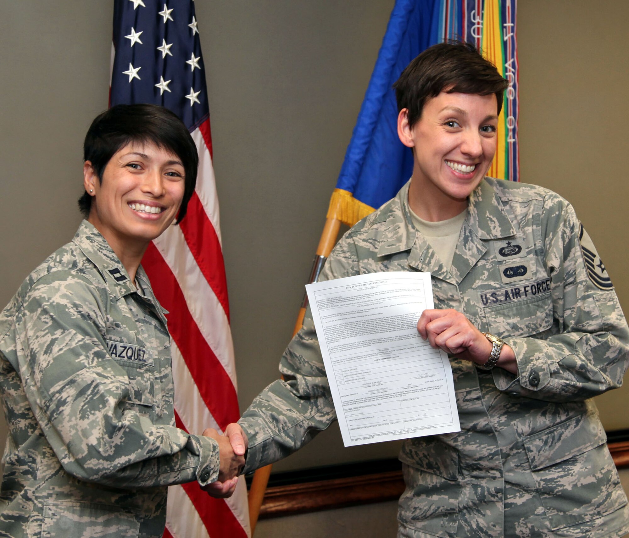 TRAVIS AIR FORCE BASE, Calif. -- Capt. Maria Rocio Vazquez is the first one to congratulate Master Sgt. Heather Bradley on her commissioning July 10, 2012. Bradley will transfer from the 349th EO office to be a medical services officer at the 349th ASTS, where Vazquez is a nurse. (U.S. Air Force photo/Lt. Col. Robert Couse-Baker)
