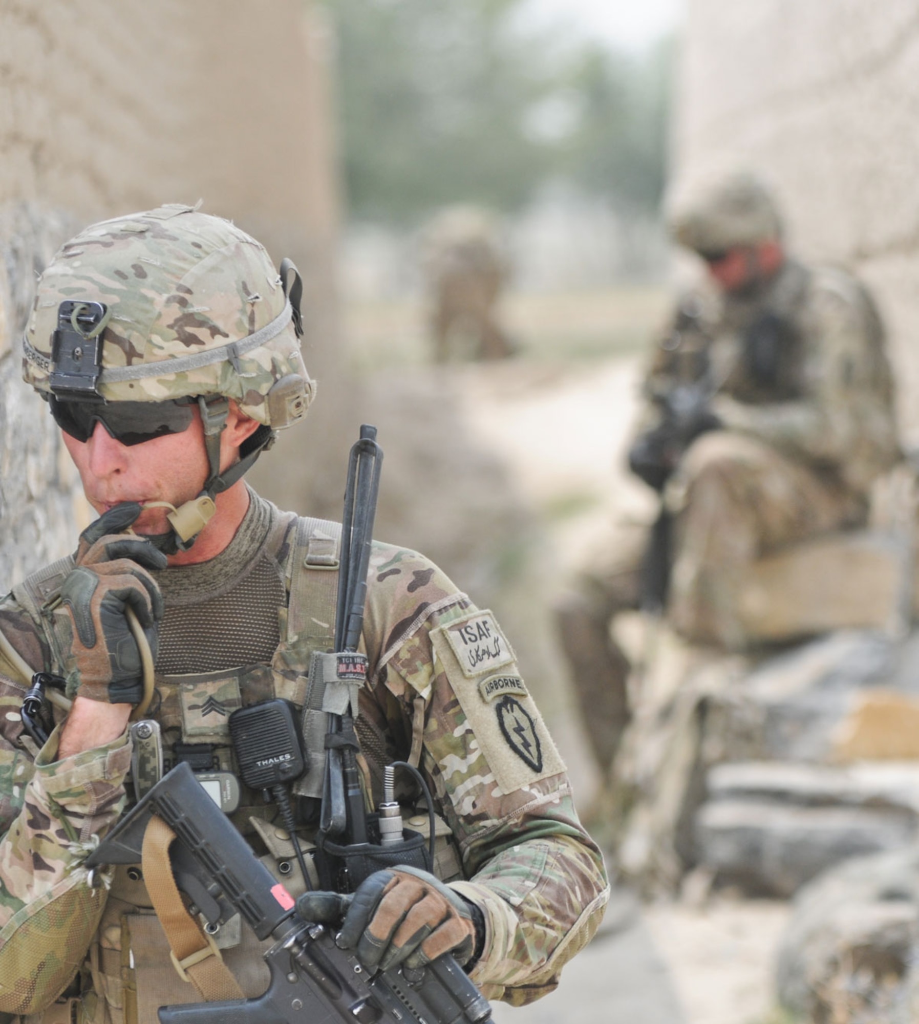 Rothenberger hydrates while pulling security at an alleyway in the village of Kunday July 7. PFAR’s mission was to facilitate members of the female engagement team as they conducted key leader engagements to promote a female health education program.. (U.S. Army photo/Staff Sgt. Jason Epperson)