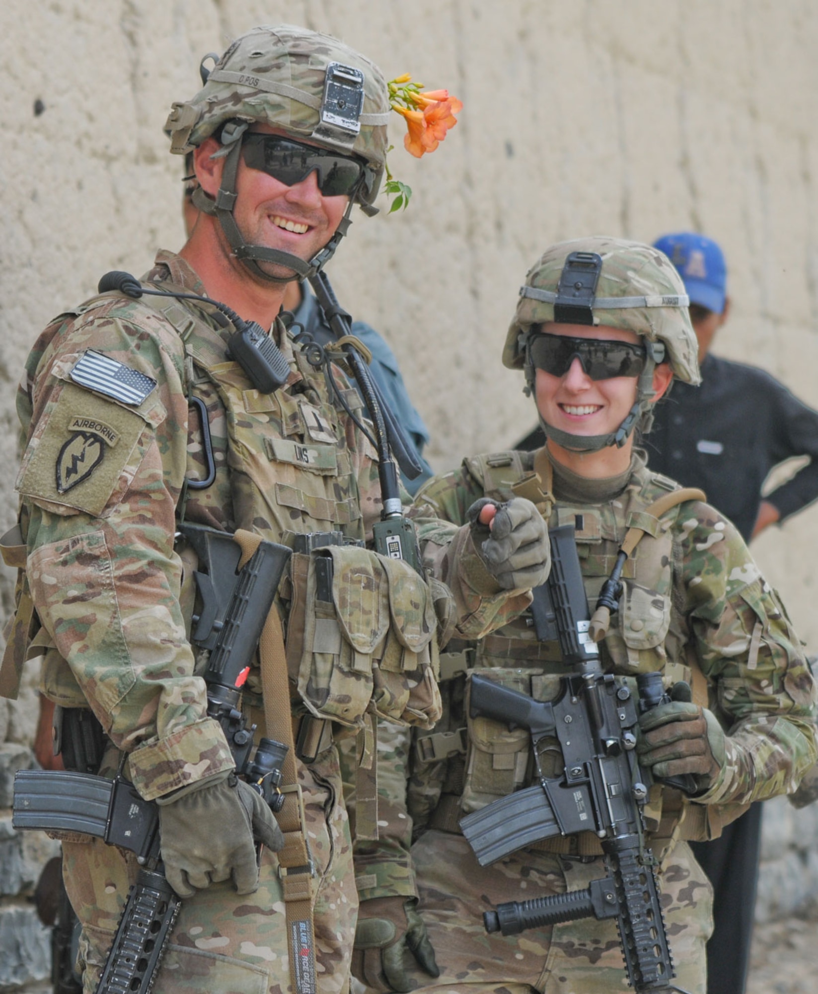 Army 1st Lt. Greg Lins, a native of Point Pleasant, N.J., 3rd Platoon leader, A/2-377th PFAR, and Army 1st Lt. Kelsie August, a native of Petoskey, Mich., part of the PFAR Female Engagement Team show off the flowers August received during a meeting with the women’s school in Mangus July 7. (U.S. Army photo/Staff Sgt. Jason Epperson)