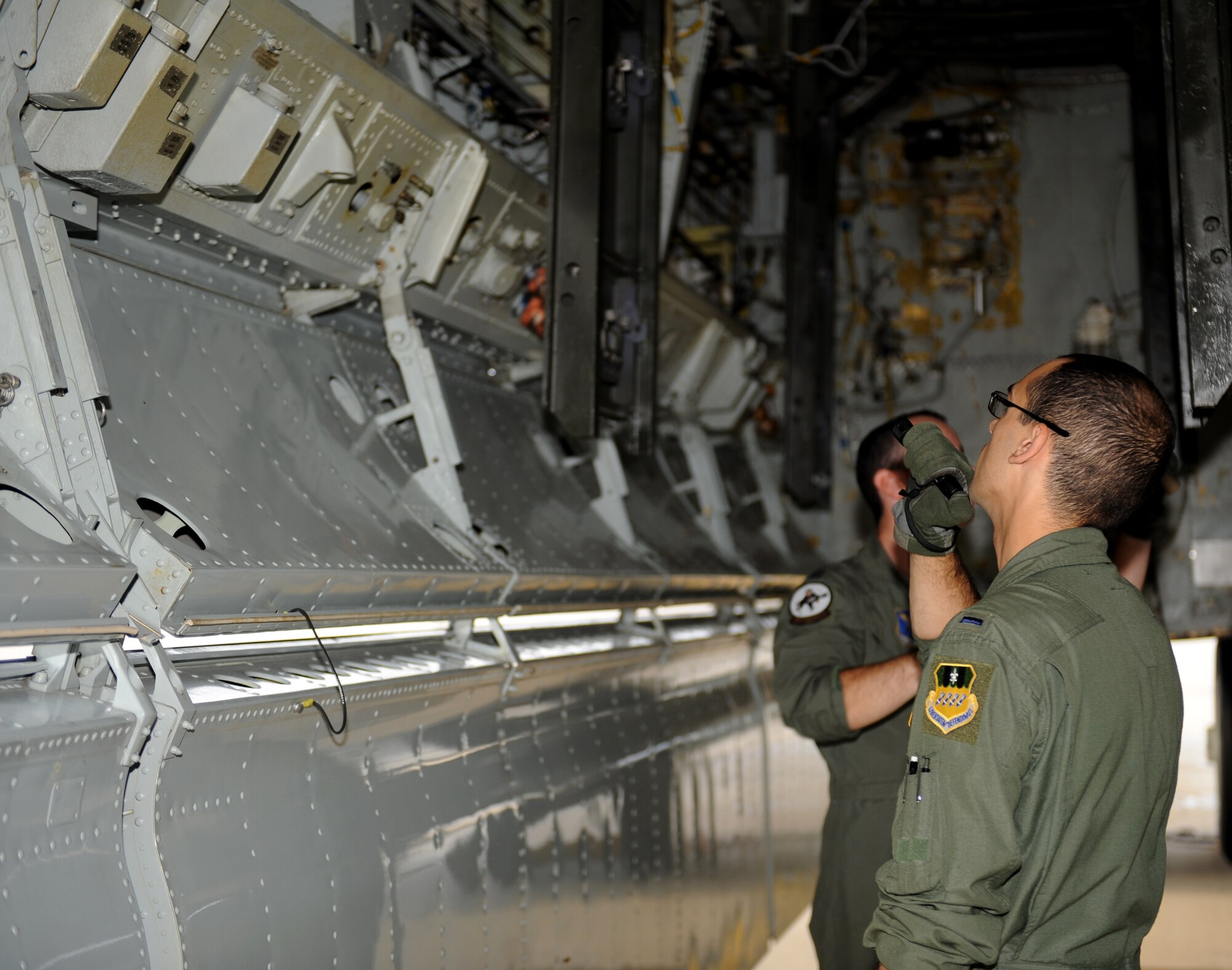 1st Lt. Jared Taylor, 11th Bomb Squadron Formal Training Unit Class 12-02 student, inspects the inside of a B-52H Stratofortress bomb bay on Barksdale Air Force Base, La., July 11. As the FTU students inspect the B-52, an instructor will accompany the students to tell them what to look for and give them guidance. (U.S. Air Force photo/Airman 1st Class Benjamin Gonsier)(RELEASED) 