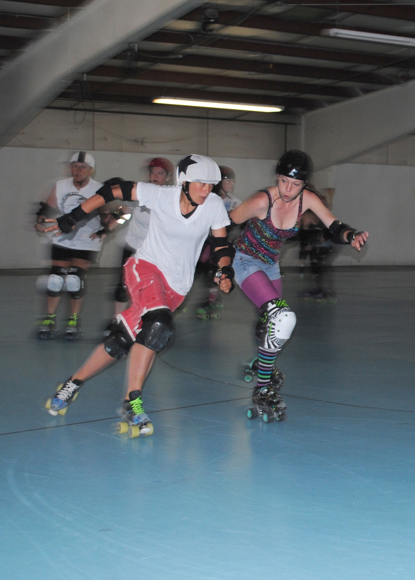 Capt. Cindy Tope, 40th Helicopter Squadron UH-1N pilot, left, tries to lap other Electric City Roller GrrrlZ members as she plays the role of a jammer during a practice at Hauers Family Skating Center on June 24. The team focuses on the basics of skating, fitness, drills and practice scrimmages in preparation for each bout. (U.S. Air Force photo/Airman 1st Class Katrina Heikkinen)