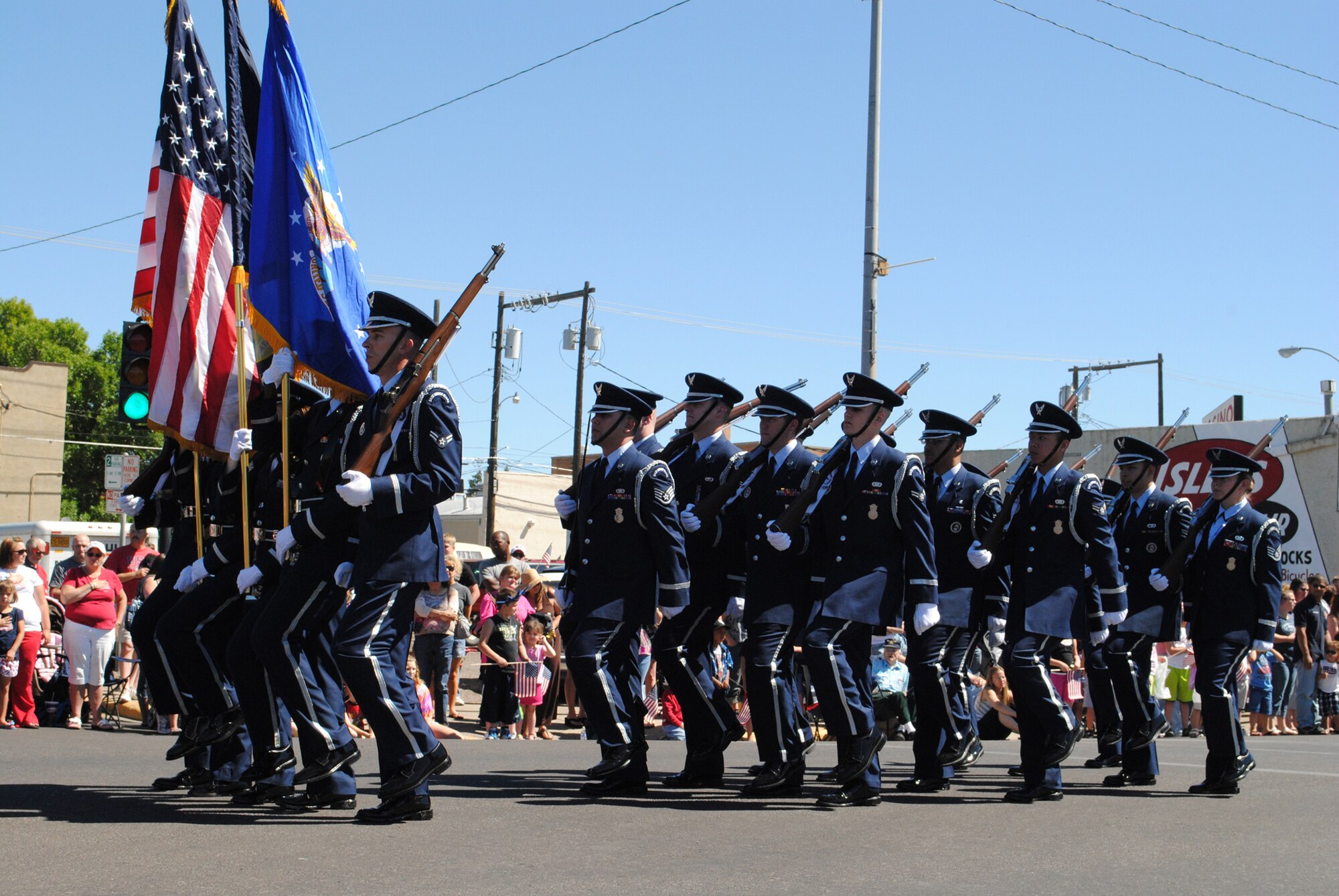 Members of Malmstrom’s Honor Guard march in step presenting the American flag at the front of the Great Falls Fourth of July Parade.  Following them were several patriotic displays, which included some vehicles and personnel from Malmstrom.  (U.S. Air Force photo/Airman 1st Class Cortney Paxton)
