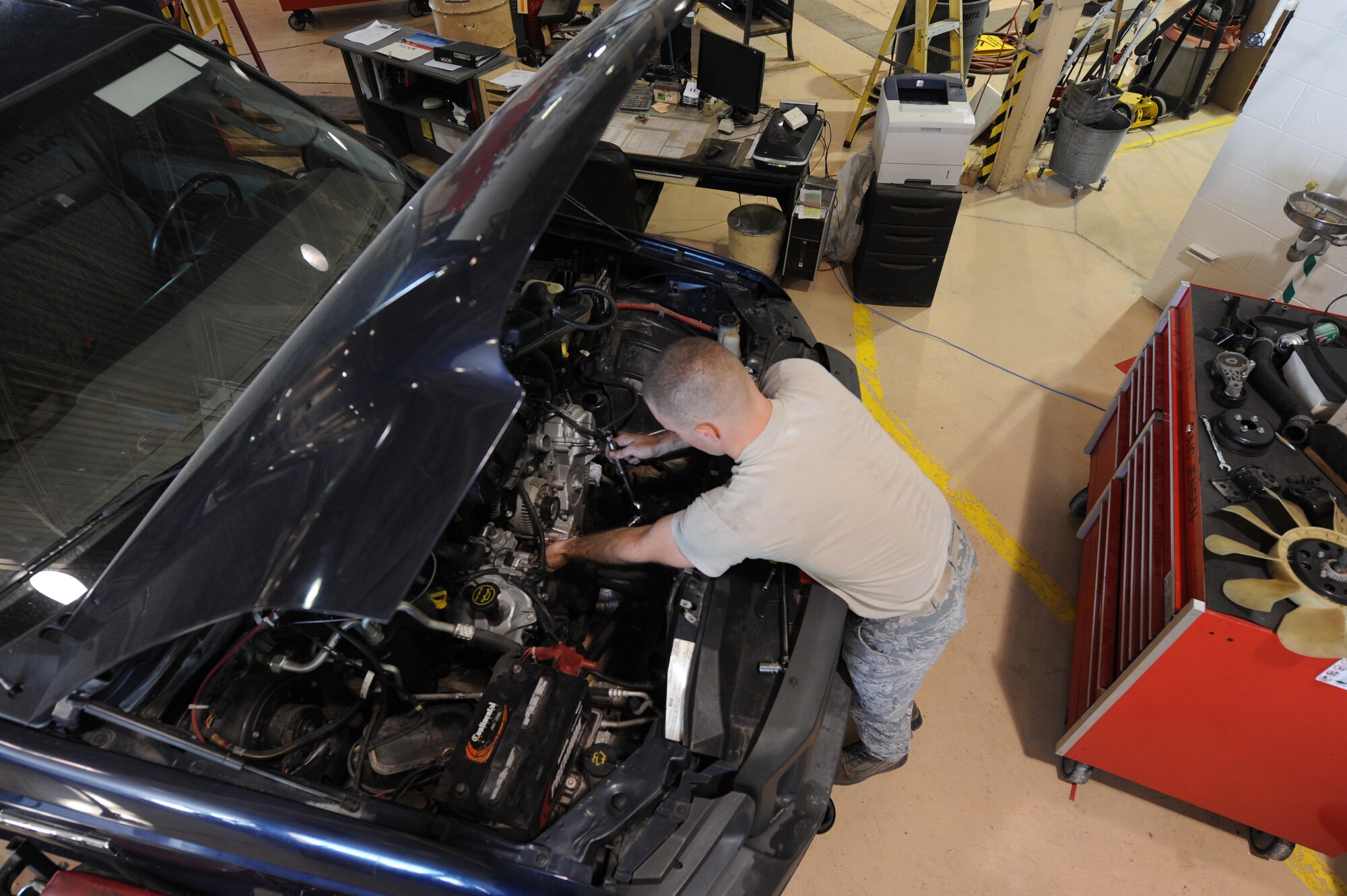 Airman 1st Class Josh Jensen, 49th Logistics Readiness Squadron vehicle equipment maintenance apprentice, works on a truck’s engine compartment at the Holloman Air Force Base N.M., vehicle shop July 12. Jensen was working on the vehicle’s front-timing cover, which is used to protect components such as the timing gears, chain and belt in the vehicle. The 49th LRS vehicle maintenance team takes care of the wing’s entire vehicle fleet. (U.S. Air Force photo by AirmanLeah Ferrante/Released)

