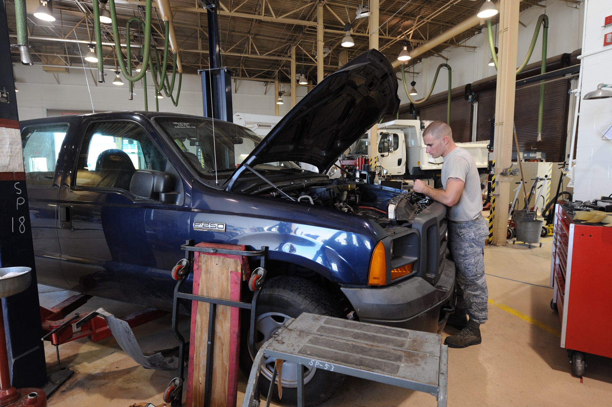 Airman 1st Class Josh Jensen, 49th Logistics Readiness Squadron vehicle equipment maintenance apprentice, looks over a truck’s engine compartment at the Holloman Air Force Base N.M., vehicle shop July 12. Jensen was working on the truck’s front-timing cover, which is used to protect components such as the timing gears, chain and belt in the vehicle. The 49th LRS vehicle maintenance team takes care of the wing’s entire vehicle fleet. (U.S. Air Force photo by Airman Leah Ferrante/Released)