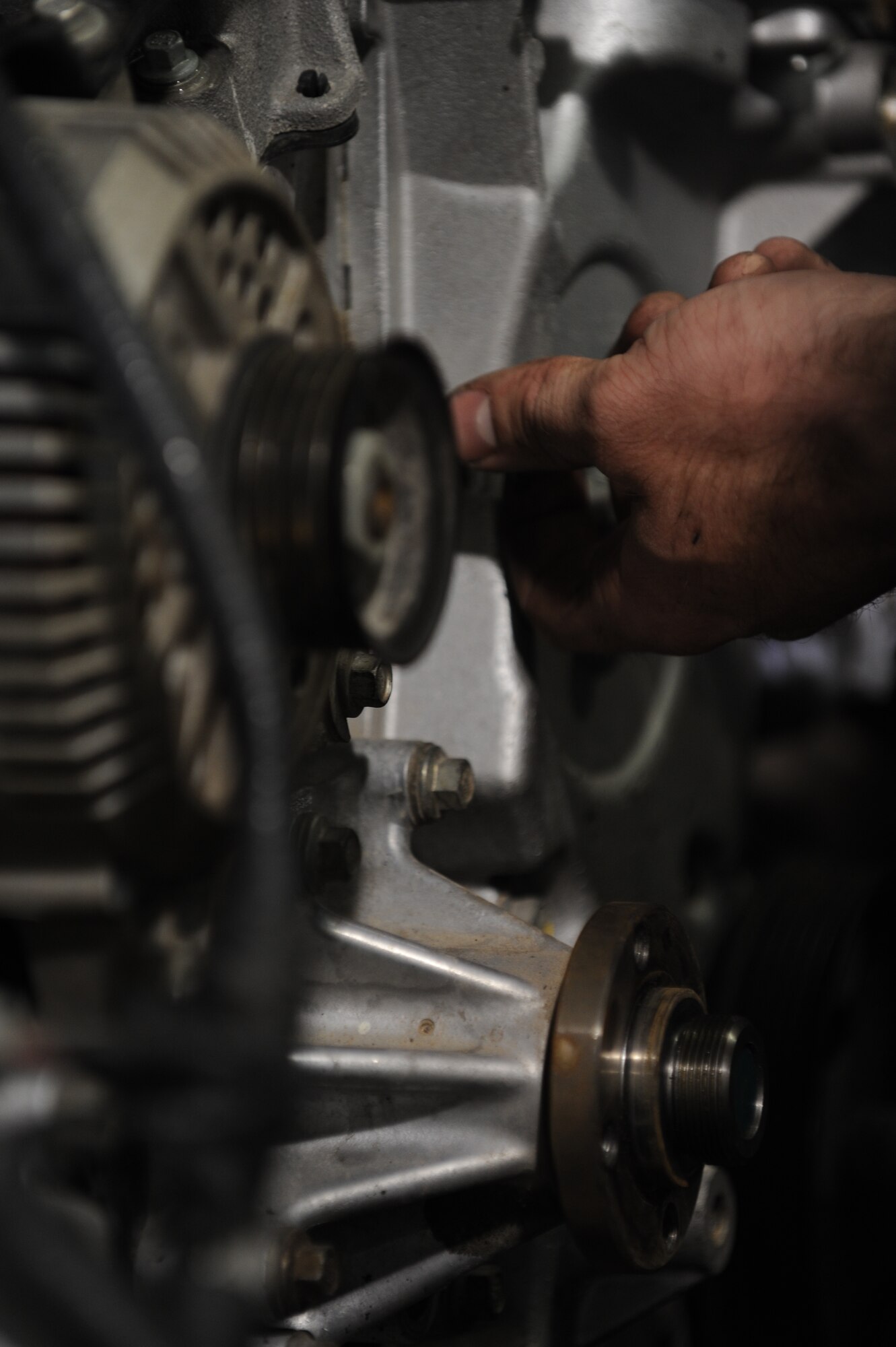 Airman 1st Class Josh Jensen, 49th Logistics Readiness Squadron vehicle equipment maintenance apprentice, loosens a truck’s bolt at the Holloman Air Force Base N.M., vehicle shop July 12. Jensen was working on the truck’s front-timing cover, which is used to protect components such as the timing gears, chain and belt in the vehicle. The 49th LRS vehicle maintenance team takes care of the wing’s entire vehicle fleet. (U.S. Air Force photo by Airman Leah Ferrante/Released)