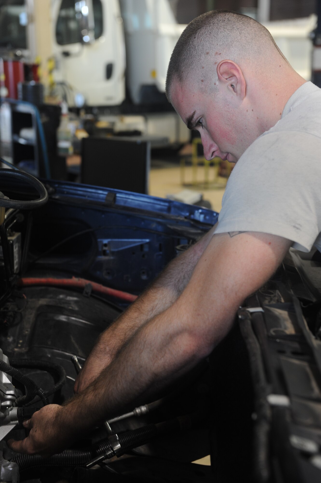Airman 1st Class Josh Jensen, 49th Logistics Readiness Squadron vehicle equipment maintenance apprentice, loosens a vehicle’s bolt at the Holloman Air Force Base N.M., vehicle shop July 12. Jensen was working on the vehicle’s front-timing cover, which is used to protect components such as the timing gears, chain and belt in the vehicle. The 49th LRS vehicle maintenance team takes care of the wing’s entire vehicle fleet. (U.S. Air Force photo by Airman Leah Ferrante/Released)