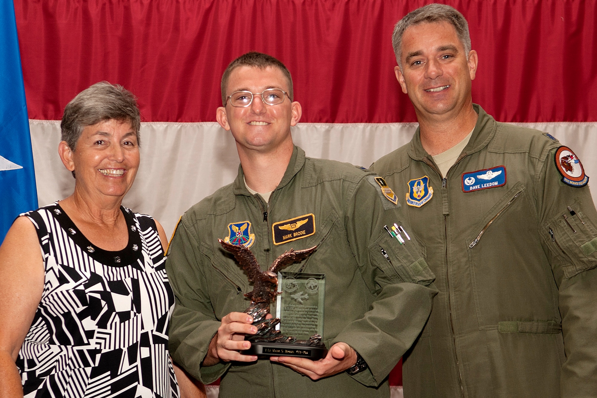 Centered between Mrs. Dianne Mabus and U.S. Air Force Lt. Col. David Leedom, 93rd Bomb Squadron commander, 1st Lt. Mark Brodie is awarded the Lindell Mabus Leadership Award during a graduation ceremony on Barksdale Air Force Base, La., July 10, 2012. The award is presented in honor of Lt. Col. Lindell Mabus, who was the first commander of the 93rd Bomb Squadron when it was reactivated in 1993 and passed away June 8, 2012. (U.S. Air Force photo by Master Sgt. Greg Steele/Released)