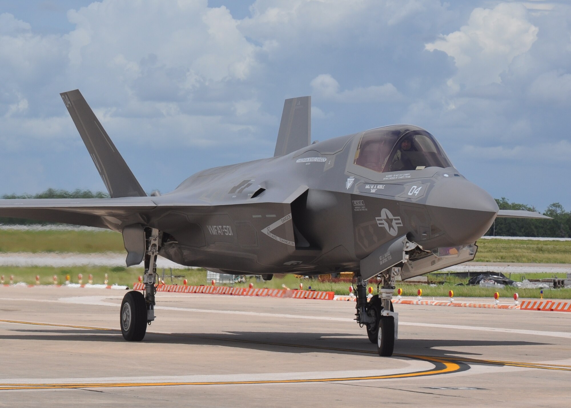 Marine Lt. Col. David Berke, commanding officer for the Marine Fighter Attack Training Squadron 501, taxis in from completing the 100th F-35 Lightning II sortie at the 33rd Fighter Wing, Eglin AFB, Fla. July 11. The 33rd FW’s 100 flights completed include 74 F-35A sorties and F-35B sorties. Current flying operations at the wing consist of Marine and Air Force fighter pilots checking out in the F-35 variants for each service.  (U.S. Air Force photo/Maj. Karen Roganov)