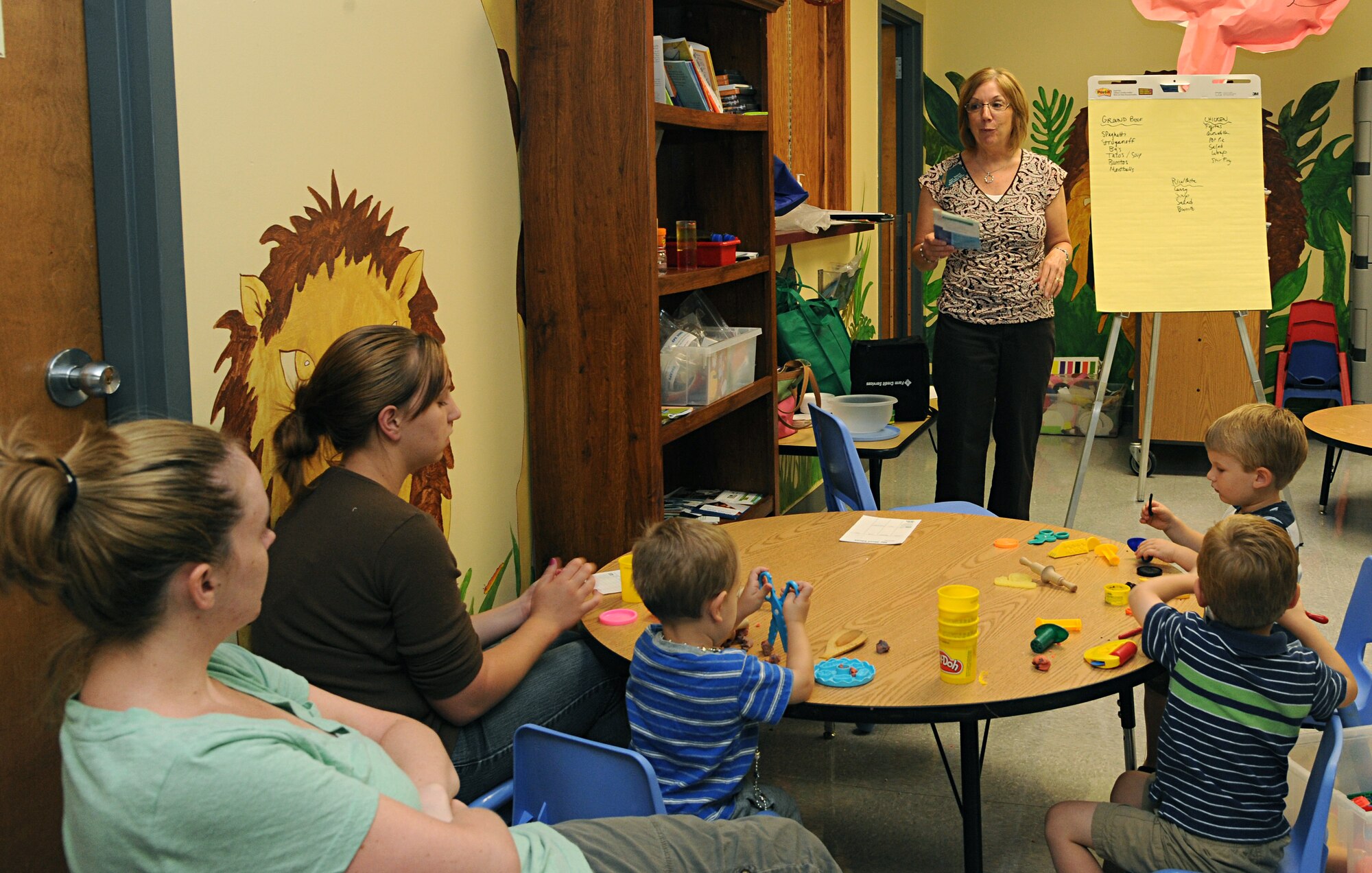 Jean Noland, Grand Forks Expanded Food Nutrition Education Program representative, speaks to parents at the Grand Forks Air Force Base Parent and Child Center, July 12, 2012. Noland is one of several briefers who visit the center periodically to educate parents on a range of topics from nutrition to general pediatrics. The center is open Monday through Friday, 9 to 11 a.m. and 1 to 3:30 p.m. For more information, call 701-747-3831 or 3241. (U.S. Air Force photo by Senior Airman Amber Bennett)