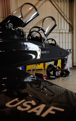 WHITEMAN AIR FORCE BASE, Mo. -- Jim Sollars and Randy Tapley, M1 Support Services contractors, replace a T-38 Talon's nose gear tire and bearings during an hourly postflight inspection here July 3. After being replaced, the old wheel assembly is taken to the 509th Maintenance Squadron Wheel and Tire Section to have a new tire installed for upcoming inspections. (U.S. Air Force photo/ Senior Airman Cody H. Ramirez)




