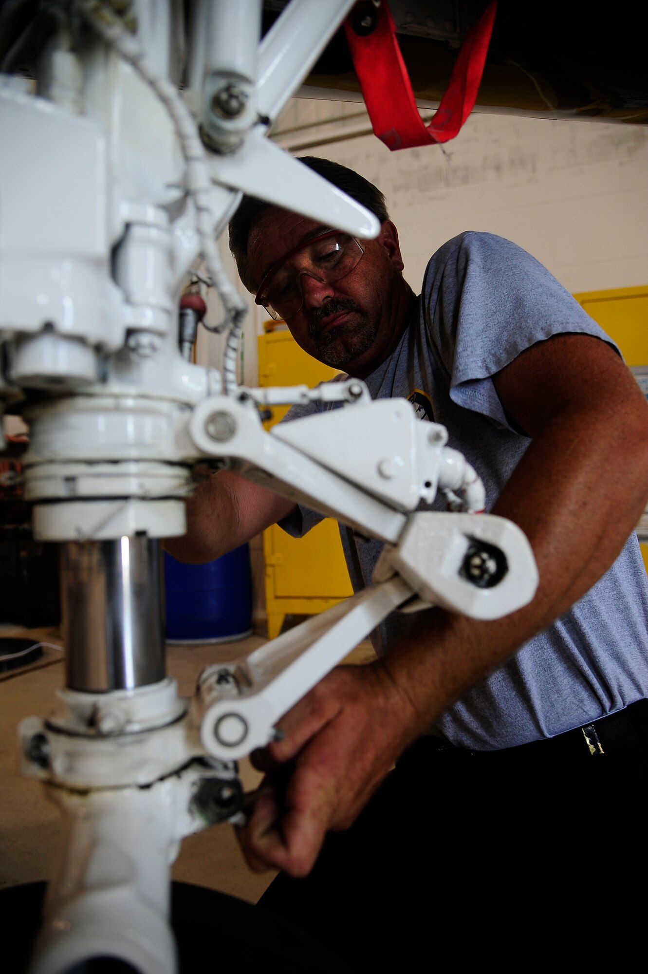 WHITEMAN AIR FORCE BASE, Mo. -- Jim Sollars, M1 Support Services contractor, places a new tire on a T-38 nose gear during an hourly postflight inspection, July 3. An HPO inspection is conducted when a Talon accrues 225 flight hours. (U.S. Air Force photo/ Senior Airman Cody H. Ramirez)
