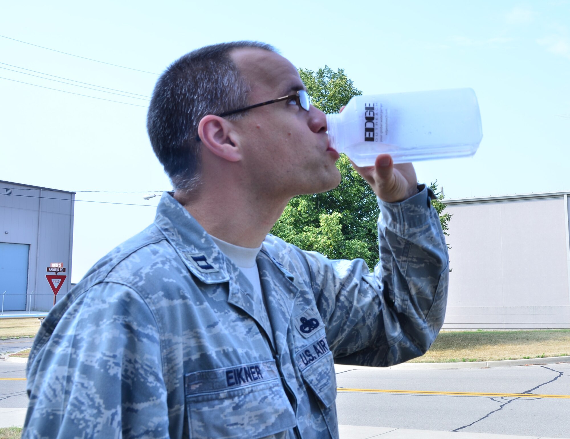 WRIGHT-PATTERSON AIR FORCE BASE, Ohio - Capt. Terrell Eikner, 445th Maintenance Squadron, samples  water from a water purification machine that was treated during a demonstration by representatives from the EDGE Outreach organization visiting the 445th Airlift Wing June 29. The 445th AW Airman’s Council is taking part in “Shoes for Water,” a shoe drive led by EDGE Outreach.  (U.S. Air Force photo/Staff Sgt. Amanda Duncan)