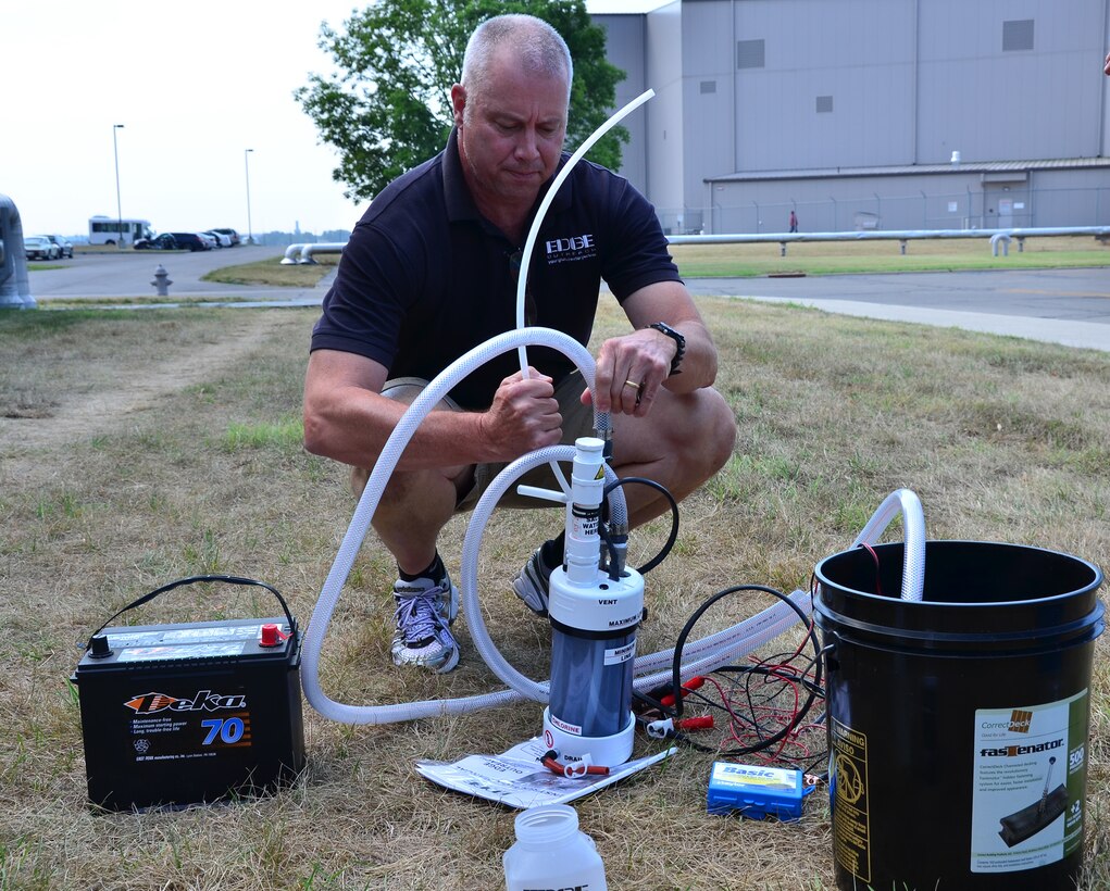 WRIGHT-PATTERSON AIR FORCE BASE, Ohio - Jeff Klingman, an EDGE Outreach representative, demonstrates the water purification machine from EDGE Outreach at the 445th Airlift Wing June 29. Trained volunteers can install a mini water treatment facility anywhere in the world that can service a village of up to 10,000 people indefinitely. (U.S. Air Force photo/Staff Sgt. Amanda Duncan)