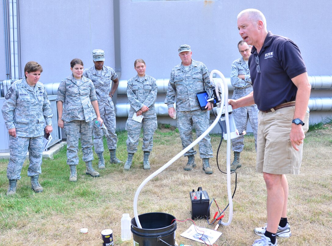 WRIGHT-PATTERSON AIR FORCE BASE, Ohio - Jeff Klingman, an EDGE Outreach representative, demonstrates the water purification machine from EDGE Outreach at the 445th Airlift Wing June 29. Trained volunteers can install a mini water treatment facility anywhere in the world that can service a village of up to 10,000 people indefinitely. (U.S. Air Force photo/Staff Sgt. Amanda Duncan)