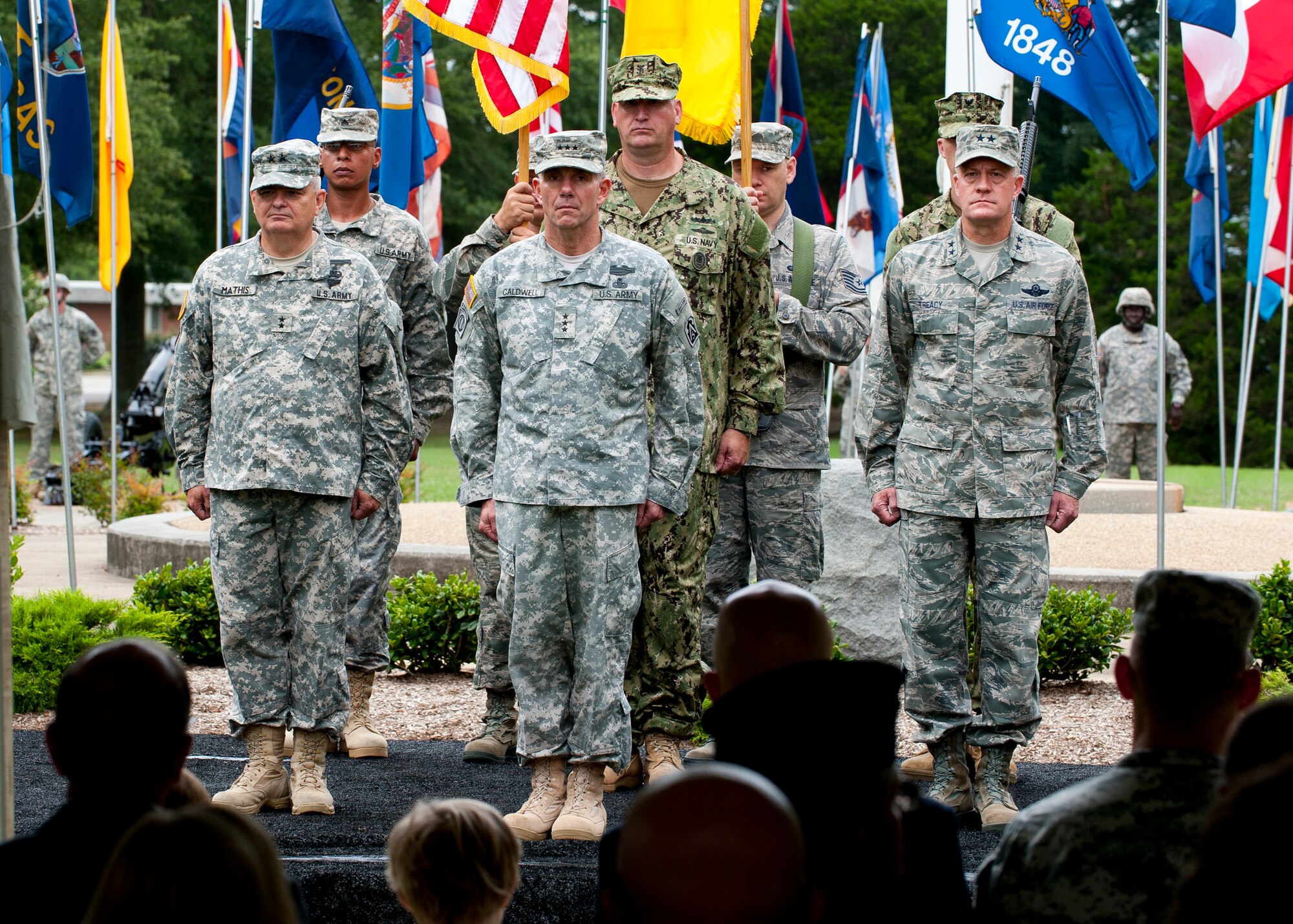 Lt. Gen. William Caldwell IV, U.S. Army North commander stands at attention with Maj. Gen. Jeff Mathis, Joint Task Force Civil Support commander and Maj. Gen. Jonathan Treacy, former Joint Task Force Civil Support commander, before the passing of the guideon, during the JTF-CS change of command, at Seay Plaza, Fort Eustis, Va., July 11, 2012. JTF-CS is a joint headquarters, comprised of more than 200 military and civilian personnel, which plans and integrates Department of Defense Support to the Primary Agency for domestic, chemical, biological, radiological and nuclear consequence management operations. (U.S. Air Force photo by Senior Airman John D. Strong II/Released)