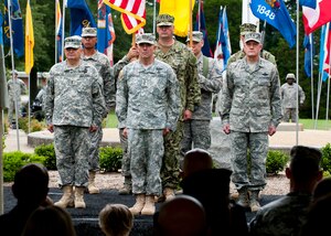 Lt. Gen. William Caldwell IV, U.S. Army North commander stands at attention with Maj. Gen. Jeff Mathis, Joint Task Force Civil Support commander and Maj. Gen. Jonathan Treacy, former Joint Task Force Civil Support commander, before the passing of the guideon, during the JTF-CS change of command, at Seay Plaza, Fort Eustis, Va., July 11, 2012. JTF-CS is a joint headquarters, comprised of more than 200 military and civilian personnel, which plans and integrates Department of Defense Support to the Primary Agency for domestic, chemical, biological, radiological and nuclear consequence management operations. (U.S. Air Force photo by Senior Airman John D. Strong II/Released)