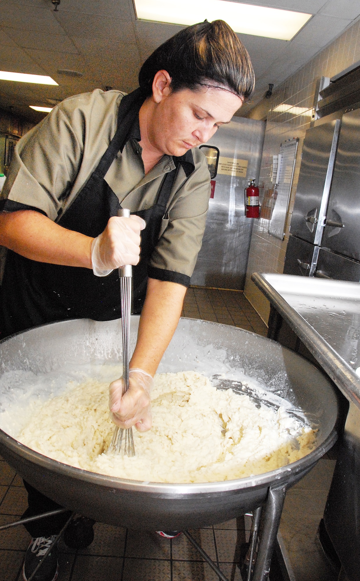 Dana Yearty, food service worker, prepares mashed potatoes for lunch at the base restaurant. (U. S. Air Force photo/Misuzu Allen)