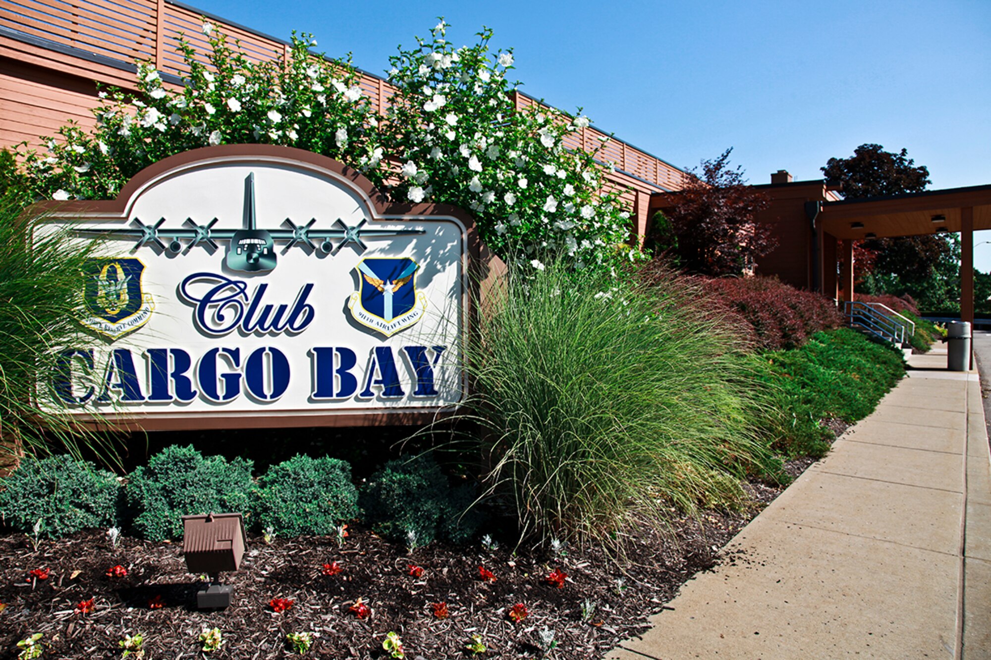 Club Cargo Bay vividly displays its sign in front of the building while service personnel work hard to facilitate military members for the upcoming July UTA, July 12, 2012. The Club offers an exclusive pre- UTA luncheon on Friday from 11 a.m. to 1 p.m. The lounge is also open on UTA Fridays and Saturdays from 4 p.m. to 10 p.m. and offers beverages and a snack menu. For additional information, contact the Club manager at 412-474-8227. (U.S. Air Force photo by Tech. Sgt. Ralph Van Houtem/Released)