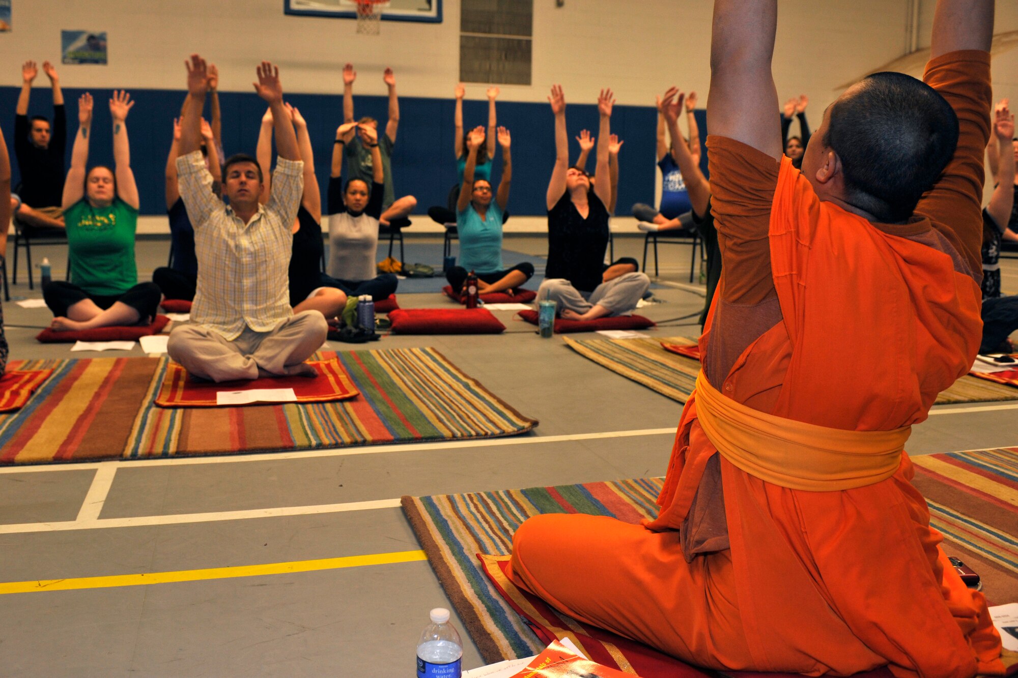 Buddhist monk Ajasn Anake leads a breathing exercise during a Buddhist meditation and yoga workshop at Cannon Air Force Base, N.M., July 8, 2012. The Base Chapel sponsored the workshop, which was held in the Youth Center and included a yoga session as well as a home-made lunch buffet. (U.S. Air Force photo by Airman 1st Class Ericka Engblom)