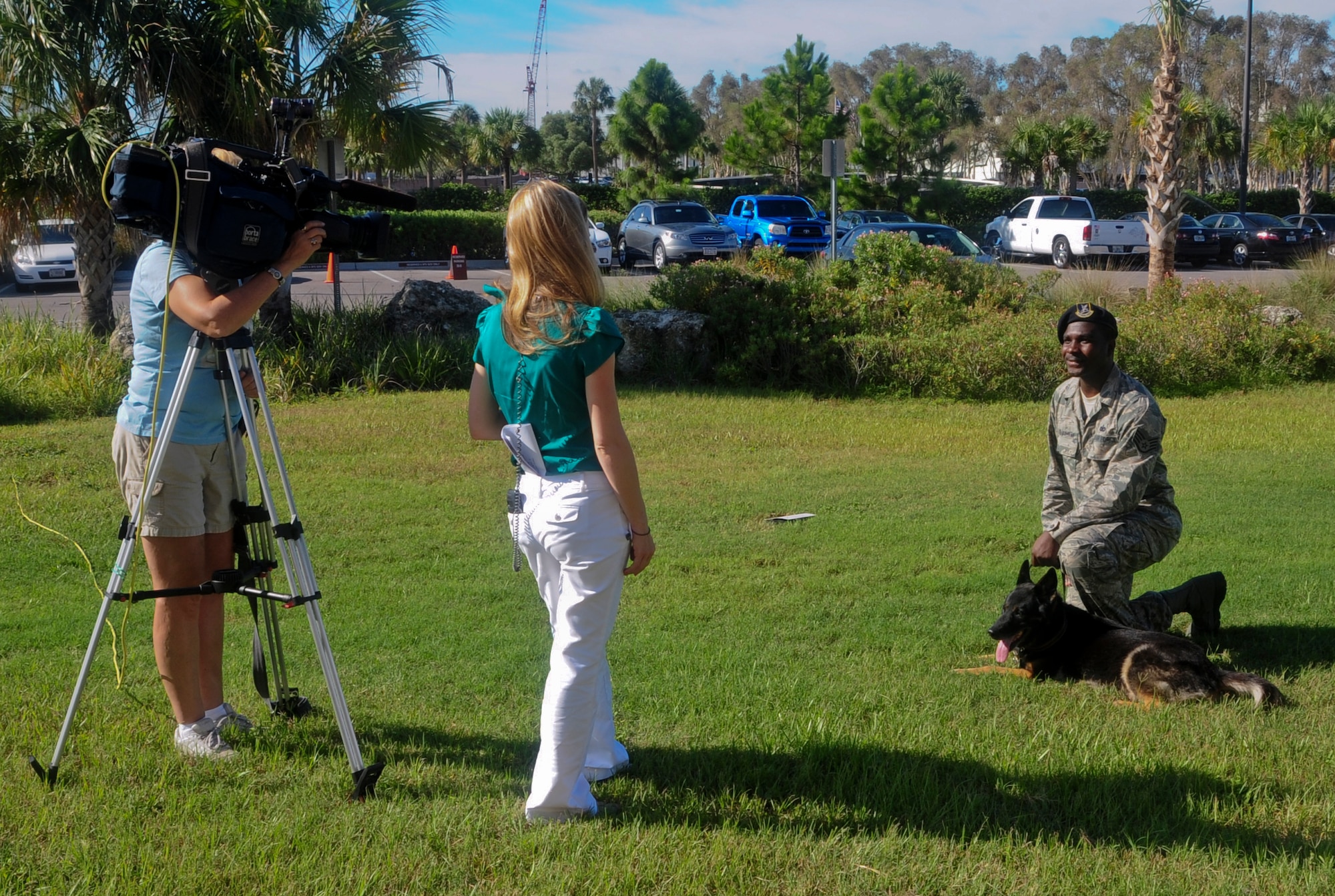 Laura Byrne, Channel 10 News representative, interviews Staff Sgt. Jarvis Beauchamp, 6th Security Forces Squadron military working dog handler, prior to a retirement ceremony in honor of his military working dog, Haris, at MacDill Air Force Base, Fla., July 12, 2012. Haris along with two other MWD’s were retired. (U.S. Air Force photo by Senior Airman Melissa Paradise/Released/cropped to point of interest)