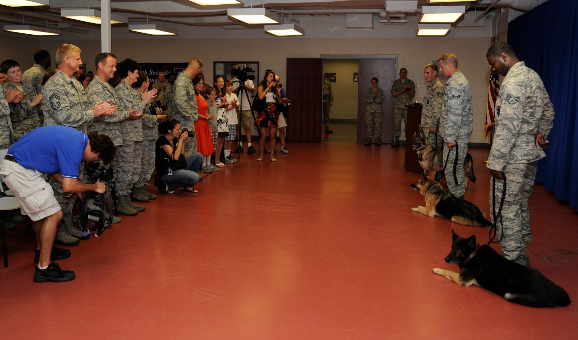 Members of the 6th Security Forces Squadron attend a retirement ceremony in honor of military working dogs Haris, Conny and Jago at MacDill Air Force Base, Fla., July 12, 2012. Conny and Jago went home with their latest handler and Haris was adopted to a Vietnam veteran and his wife. (U.S. Air Force photo by Staff Sgt. Linzi Joseph/Released/cropped to point of interest)