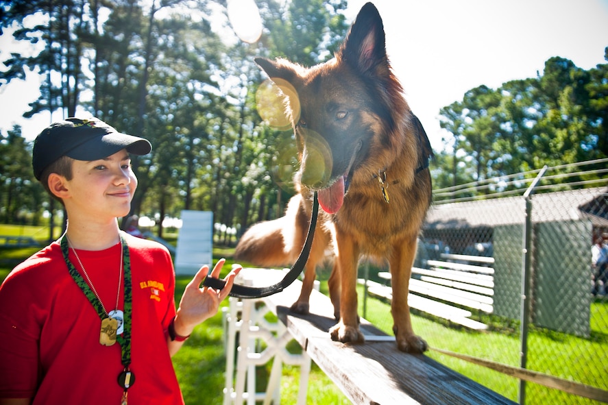 Christopher Carswell and his service dog, Bronx, maneuver through a canine obstacle course at Moody Air Force Base, Ga., July 10, 2012. Christopher, an epilepsy patient, has been paired with Bronx since 2010. Bronx helps Christopher with his mobility and has even detected some of his seizures, allowing him to receive medical attention quickly. (U.S. Air Force photo by Staff Sgt. Jamal D. Sutter/Released)