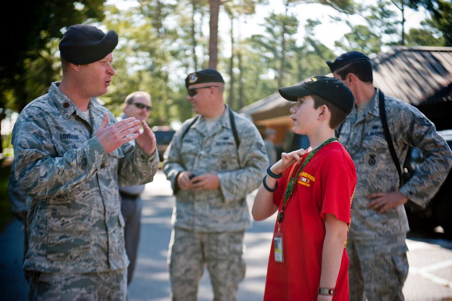 U.S. Air Force Maj. Brian Loveless, 23d Security Forces Squadron commander, and Christopher Carswell speak about military working dogs at Moody Air Force Base, Ga., July 10, 2012. Christopher visited Moody to shadow the base’s MWD unit and become an honorary dog handler for the day. (U.S. Air Force photo by Staff Sgt. Jamal D. Sutter/Released) 