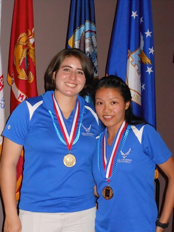 NAVAL AIR STATION GREAT LAKES, Ill. – Capt. Virginia L. Aguilar, 97th Medical Support Squadron medical logistics flight commander, and Capt. Sally L. To, 97th MDSS pharmacy services chief, don their gold medals at the All-Armed Forces Volleyball tournament awards ceremony, June 26, 2012. The Air Force Women’s Volleyball team dominated the tournament with a 6-0 victory over the Army, Navy, and Marine Corps women’s volleyball teams. (Courtesy photo by Capt. Virginia L. Aguilar / 97th Medical Support Squadron / Released)