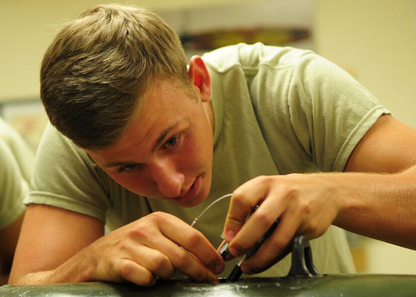 Air Force Academy Cadet Blake Jones, from Portland, Ore., plugs in a fuse for a 500 pound bomb at Beale Air Force Base, Calif., July 11, 2012. The students were here as part of Operation Air Force, a program that allows cadets to experience military life. (U.S. Air Force photo by Senior Airman Shawn Nickel/Released)