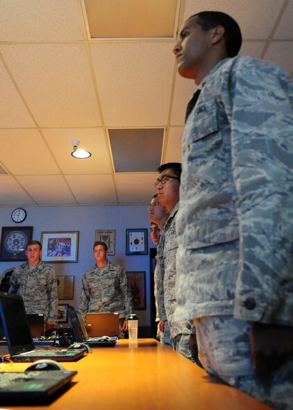 Air Force Academy cadets snap to attention to show respect for the commander of the Air Force Combat Ammunitions School, Maj. Aaron Maynard July 11, 2012. Groups of cadets are visiting Beale and other bases throughout the summer to get a taste of Air Force careers and the military lifestyle. (U.S. Air Force photo by Senior Airman Shawn Nickel/Released)