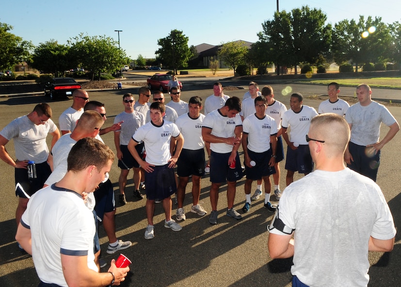 Cadre at the Air Force Combat Ammunitions School, Beale Air Force Base, Calif., explain proper hydration to Air Force Academy cadets after physical training July 11, 2012. During the cadets visit to Beale temperatures soared to more than 104 degrees. (U.S. Air Force photo by Senior Airman Shawn Nickel/Released)