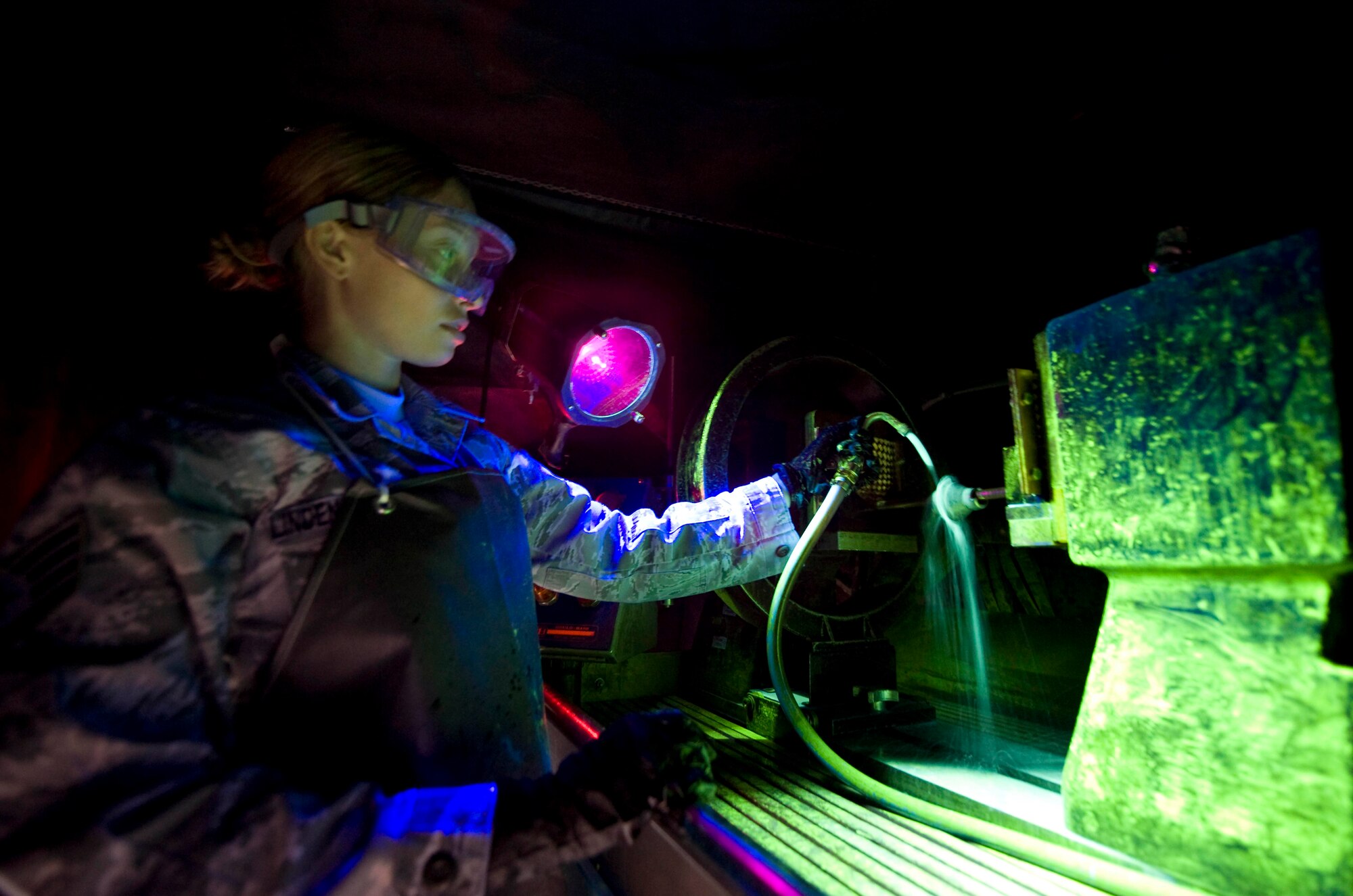 U.S. Air Force Staff Sgt. Rebeca Linden de Romero, 379th Expeditionary Maintenance Squadron Non-Destructive Inspection technician, sprays a magnetic particle solution on an aircraft component before performing a magnetic particle inspection in Southwest Asia, July 11, 2012. A magnetic particle solution is used to fill in cracks when damage equipment is suspected.  This material will then glow under a black light identifying any damage. Linden de Romero is deployed from Travis Air Force Base, Calif., and is a native of Durango, Mexico. (U.S. Air Force photo/Staff Sgt. Sheila deVera)