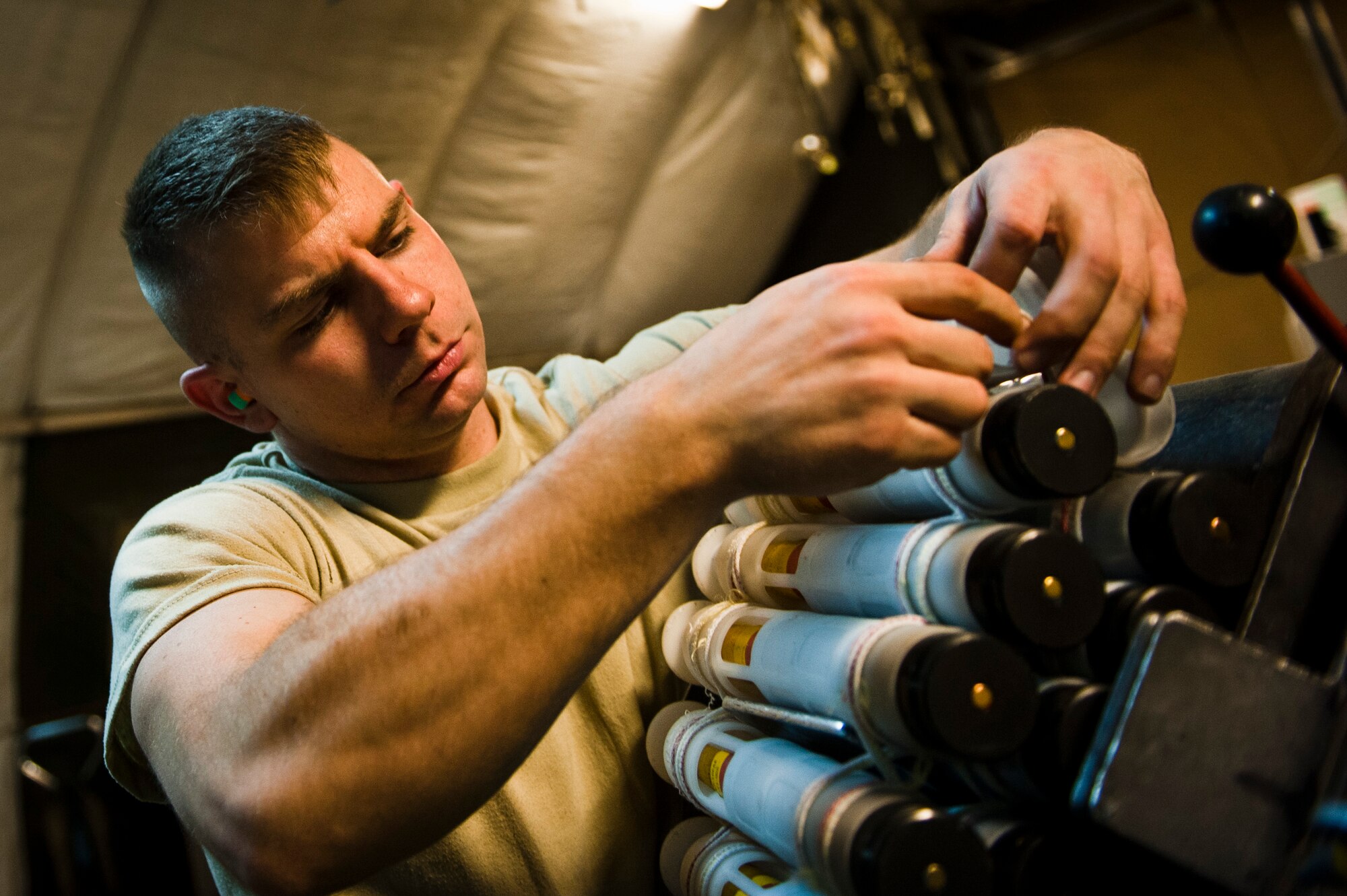 SrA Jerry Satterfield, Munitions Systems Specialist with the 455th Maintenance Squadron, loads 30mm High Explosive Incendiary rounds into containers to be loaded on U.S. Air Force A-10 Thunderbolt IIs at Bagram Airfield, Afghanistan, June 29, 2012. Satterfield and his fellow maintainers sustain the fight by providing reliable, precise firepower to BAF’s aircrews. (U.S. Air Force photo/Capt. Raymond Geoffroy))