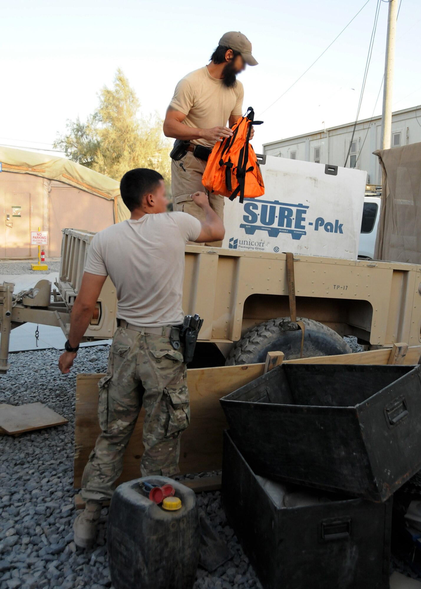 Air Force service members from an expeditionary unit load a large cargo container of more than 140 backpacks filled with school supplies for a humanitarian mission, here in Kandahar Province, Afghanistan, June 18, 2012. The humanitarian mission delivered school supplies for Afghan teachers and students at a local school. The supplies were donations collected stateside by the project lead's family, friends, and church. (U.S. Air Force photo/Staff Sgt. Heather Skinkle